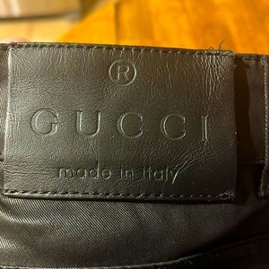 Gucci pants, black with gold buttons and zippered legs. Excellent condition.